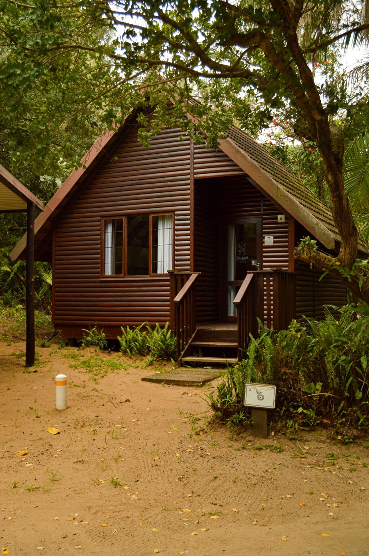 Standard A-frame chalet among leafy trees